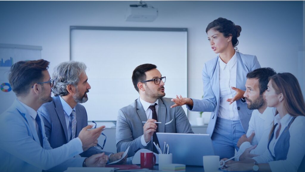 A professional woman leading a collaborative business meeting to discuss b2b appointment setting services for the IT channel.