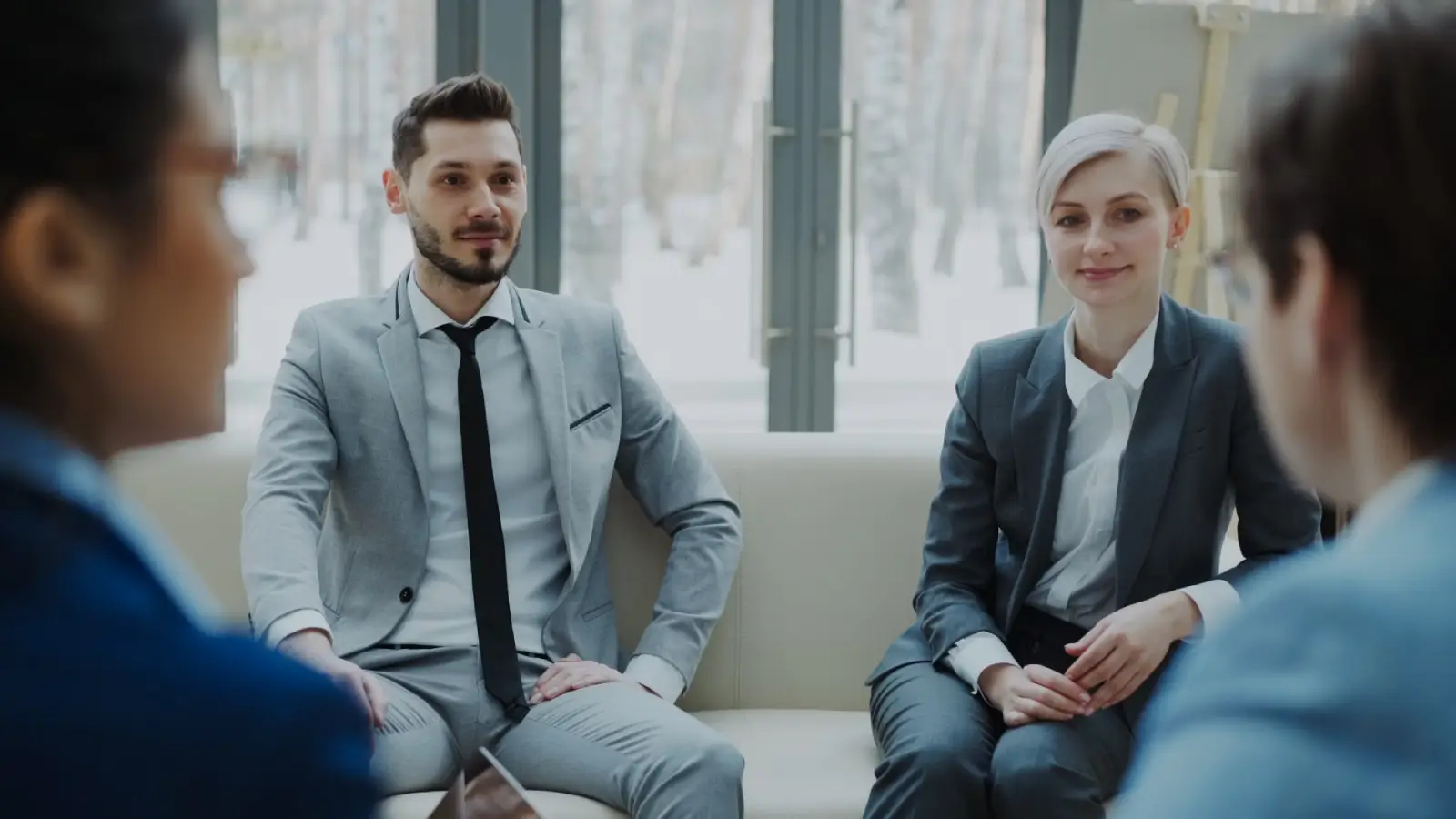 Two enterprise professionals reviewing partnership strategy in a modern office