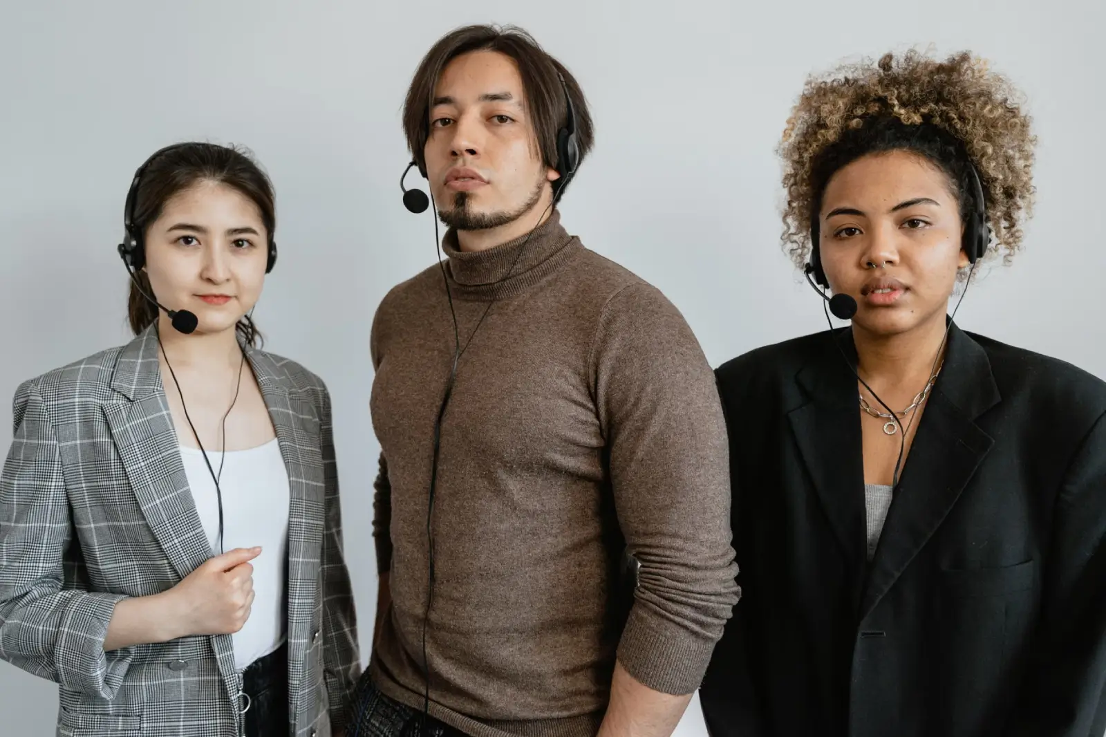 Diverse outbound sales team with headsets working in a modern enterprise office